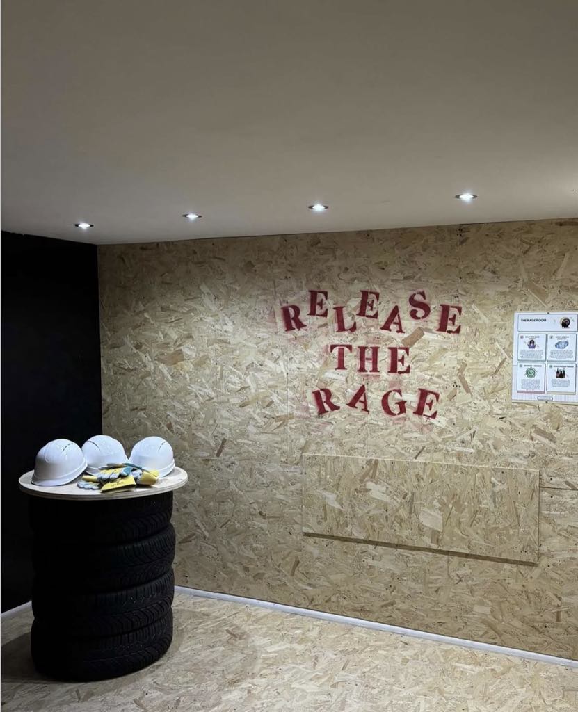 The All Ears Rage Room with a Release the Rage wall, hard hats and protective gear