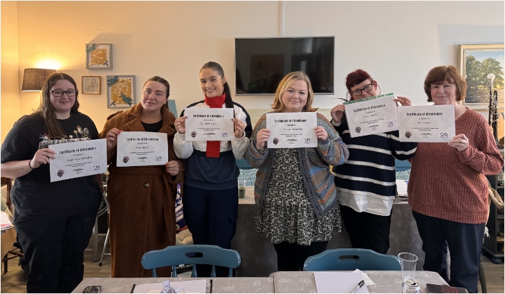 A group holding their certificates after completing an All Ears CPD course